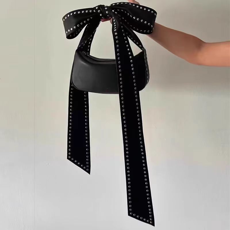Bolso de mano con lazo y remaches – estilo moderno y funcional